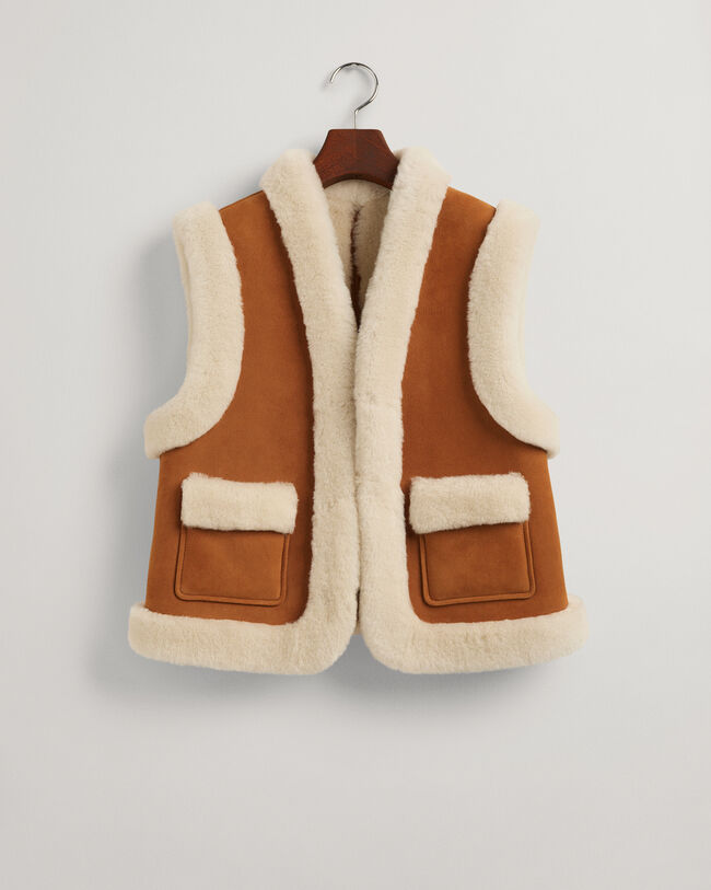 Piumino smanicato in shearling
