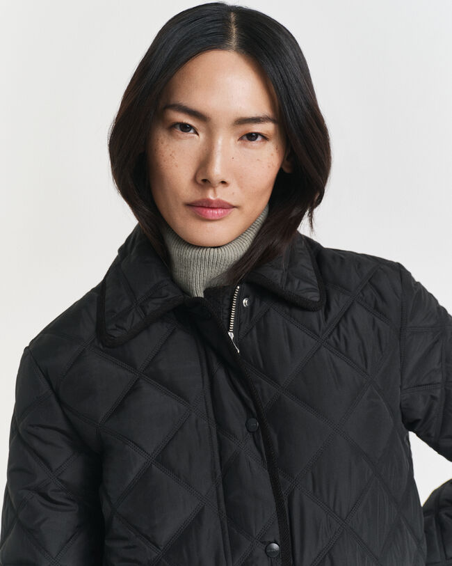 Piumino trapuntato con finiture in velluto a coste